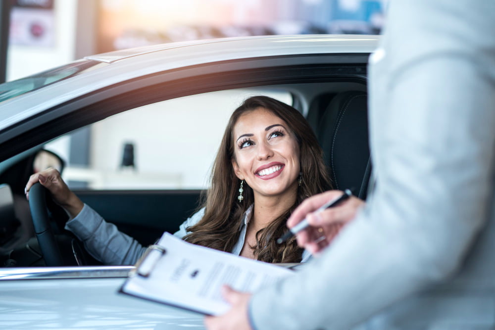 happy customer buying brand new car local car dealership